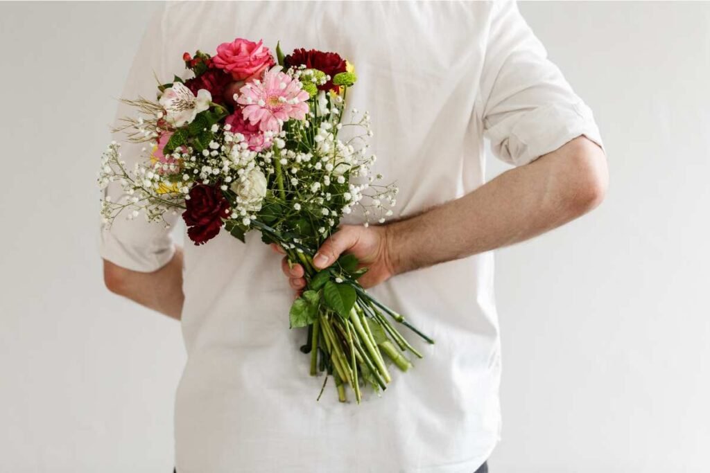 How to Tell if He’s Into You: The Subtle (and Not-So-Subtle) Signs 1 man holding flowers